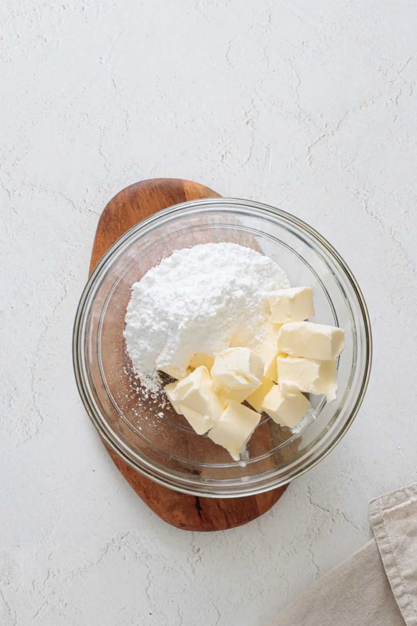 Softened butter and powdered sugar in a glass mixing bowl