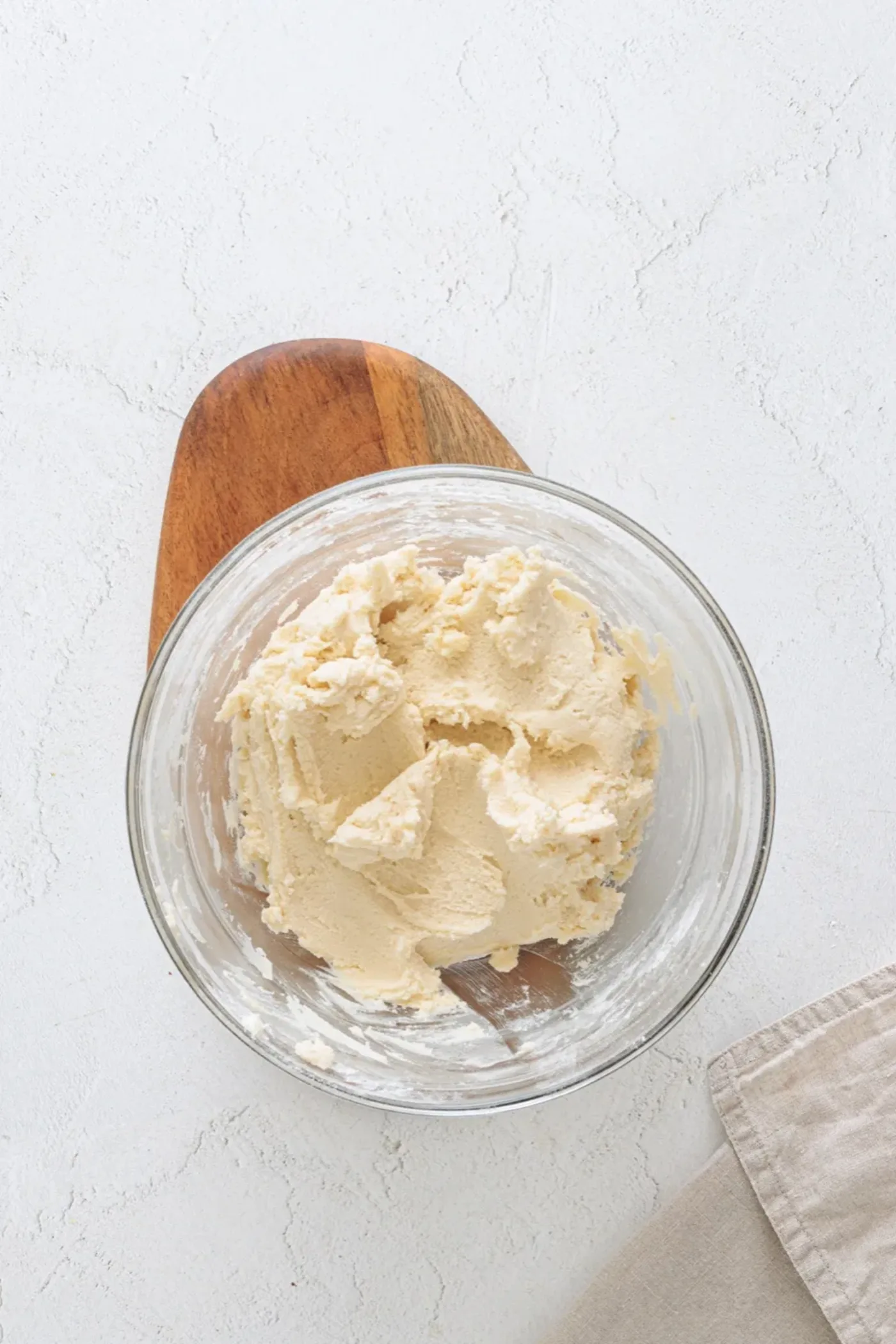 Soft pale cookie dough in a glass bowl