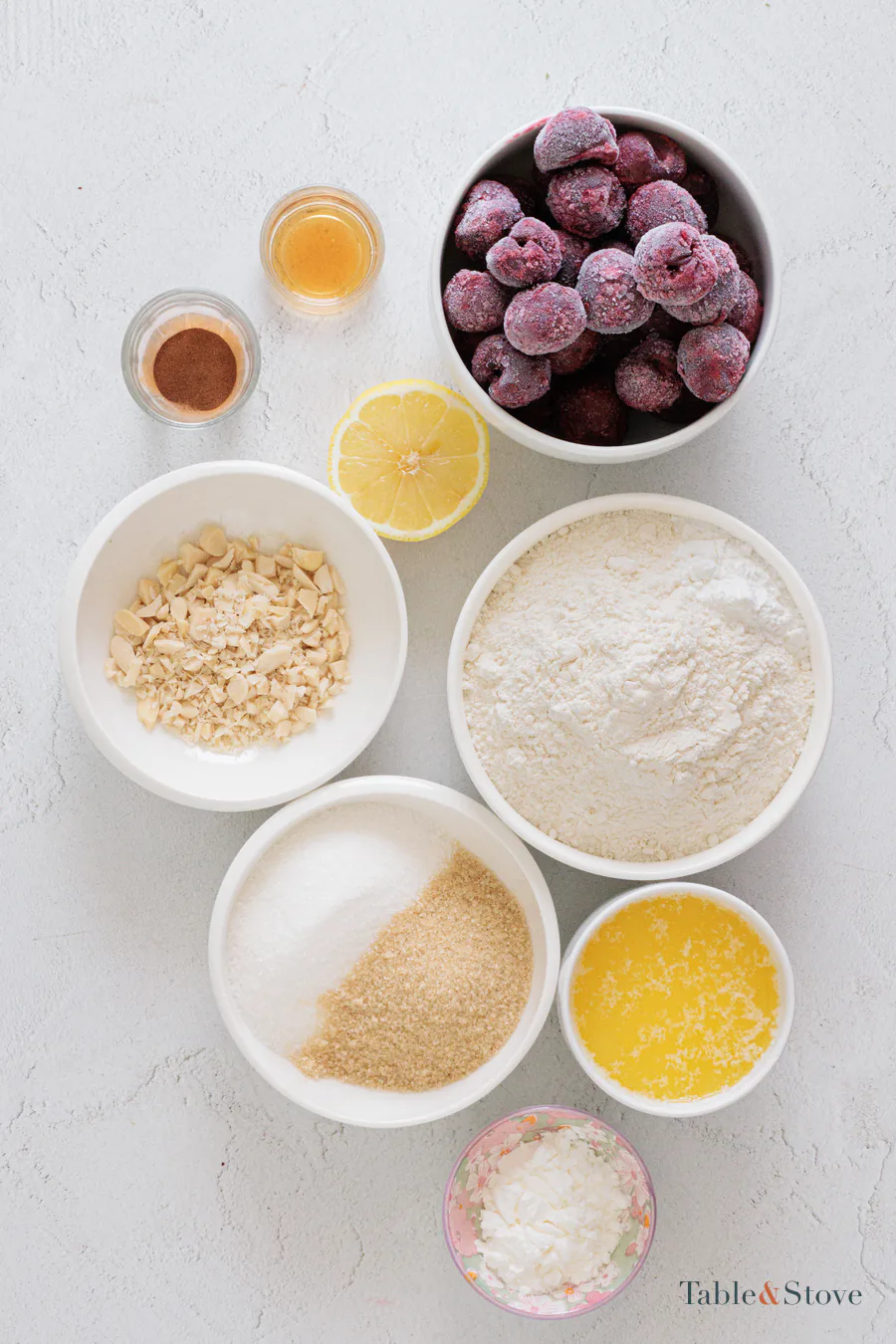 Cherry pie bar ingredients arranged in bowls on a pale work surface