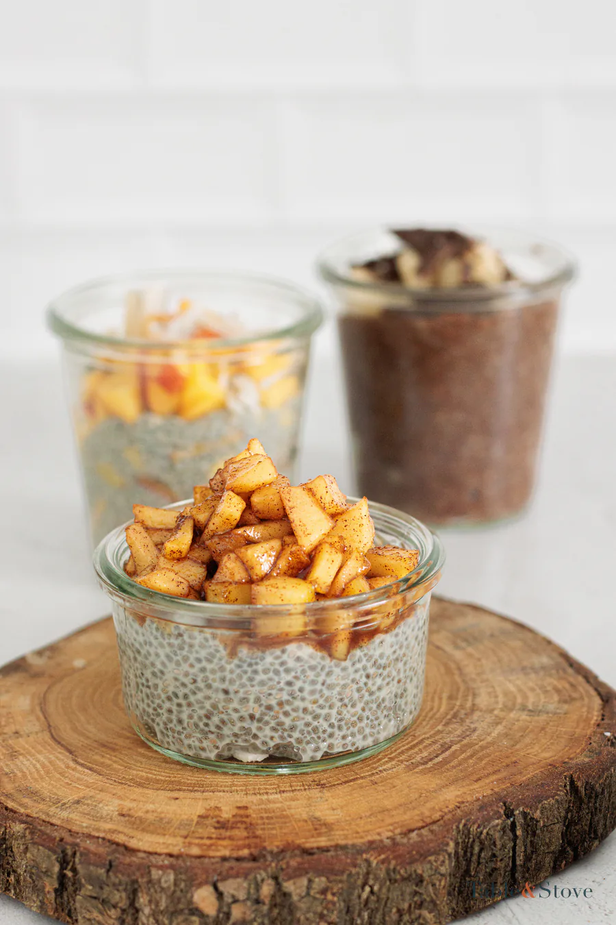 Apple cinnamon chia pudding in front of the peach and chocolate variations