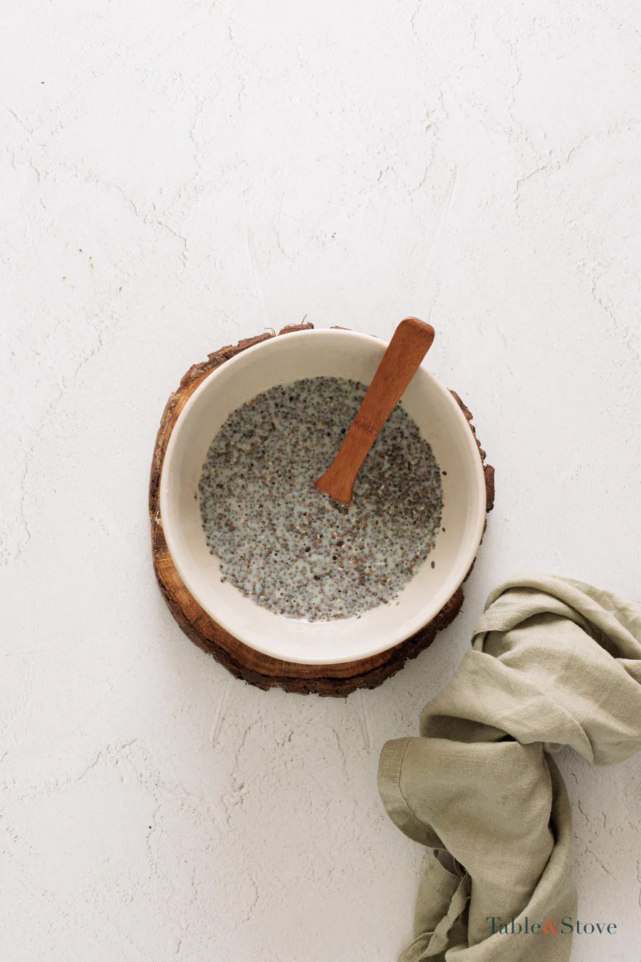 Chia seeds evenly mixed through milk in a white bowl