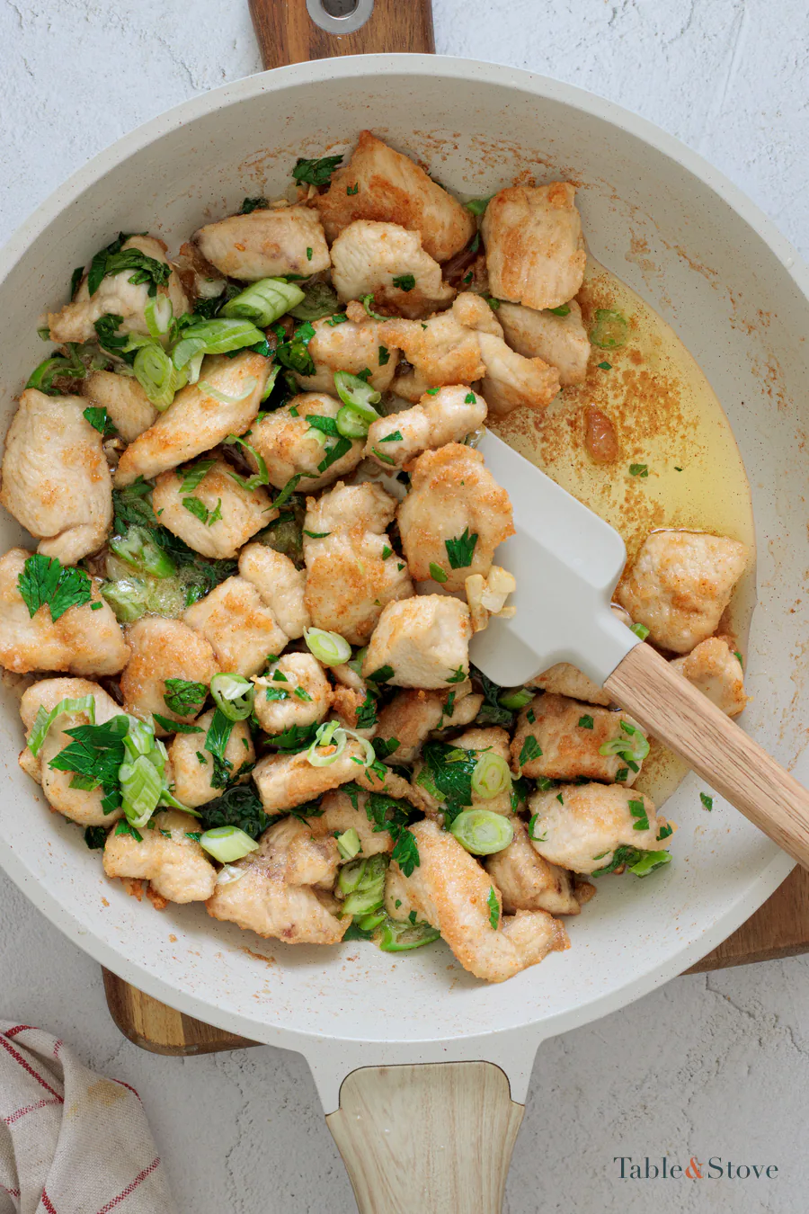 Finished garlic butter chicken bites being stirred in the skillet
