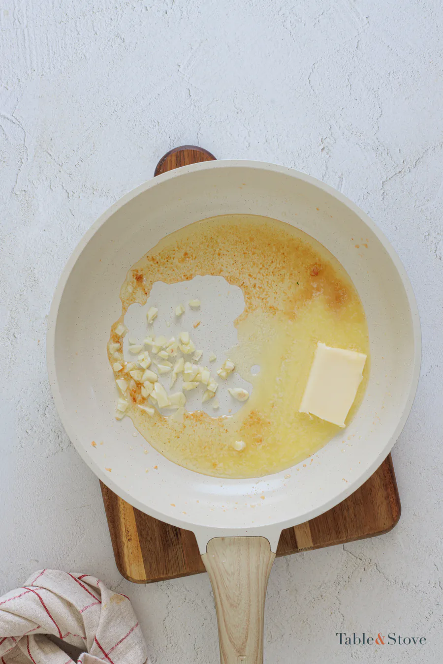 Chopped garlic and butter melting in the browned skillet