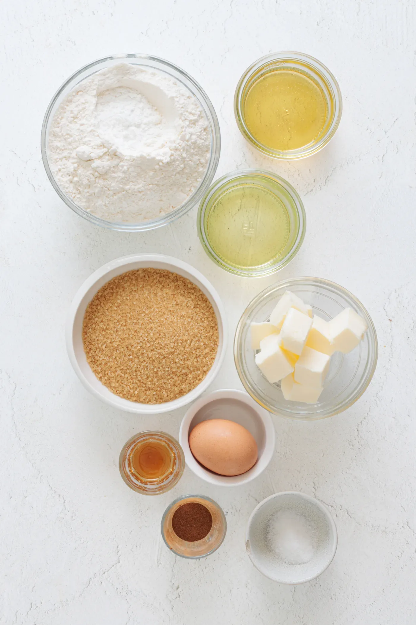 Measured flour, butter, brown sugar, honey, egg, cinnamon, oil, vanilla, and salt for honey cinnamon cookies