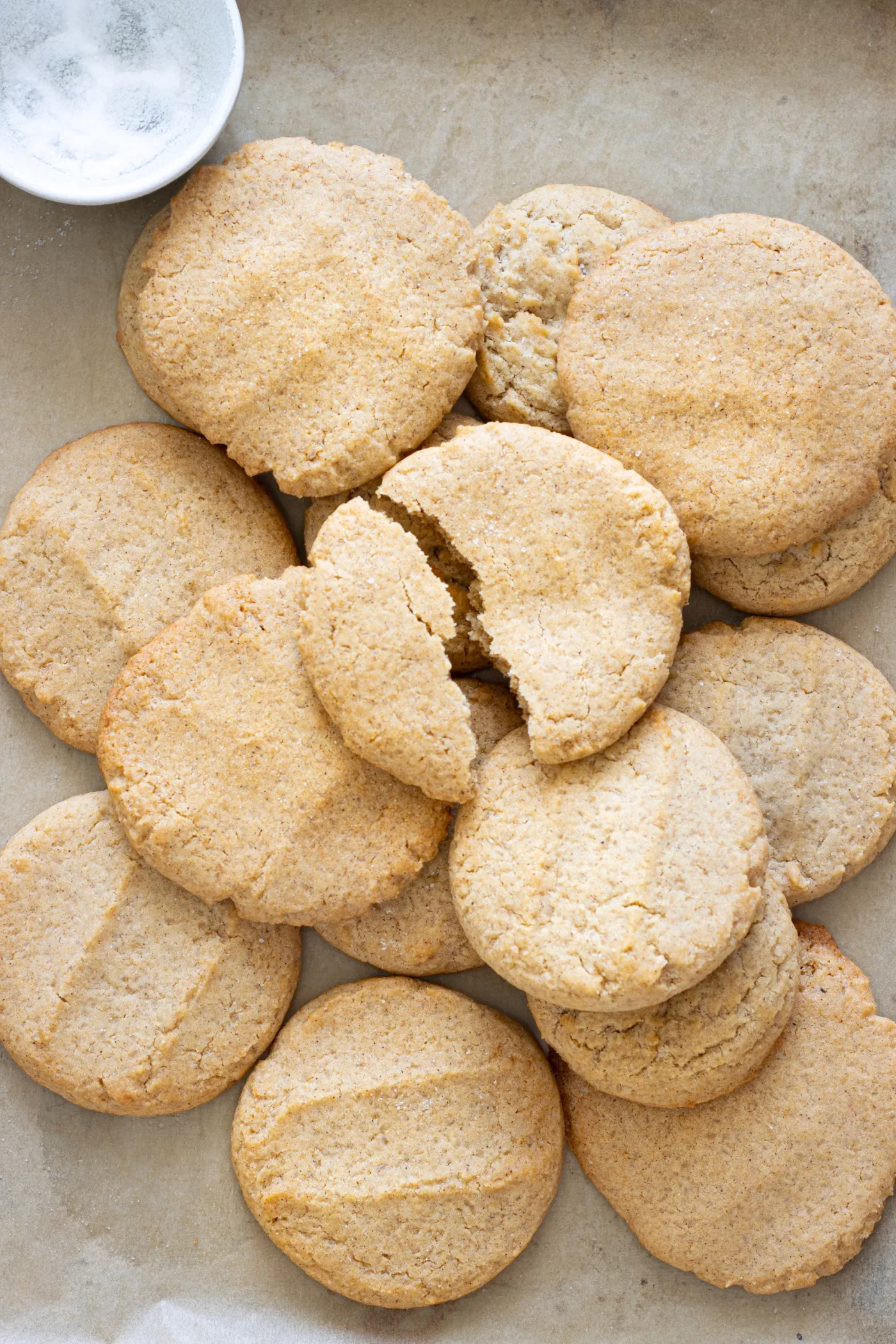 Baked honey cinnamon cookies with lightly golden edges on parchment paper