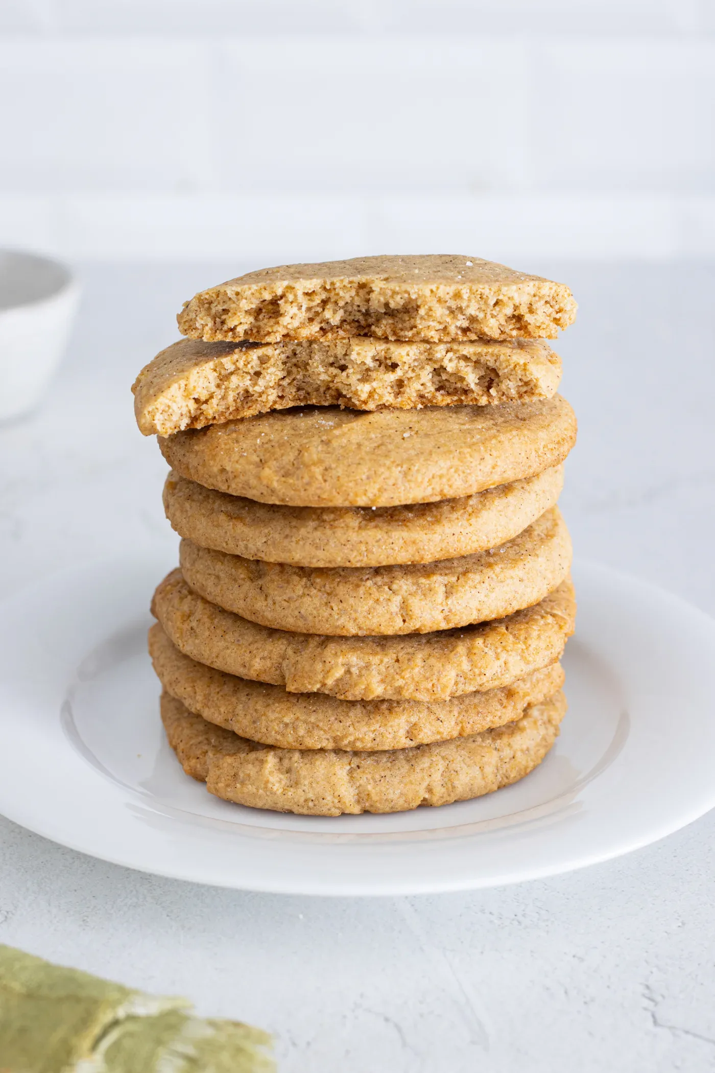 Stack of honey cinnamon cookies with one broken cookie showing its soft center