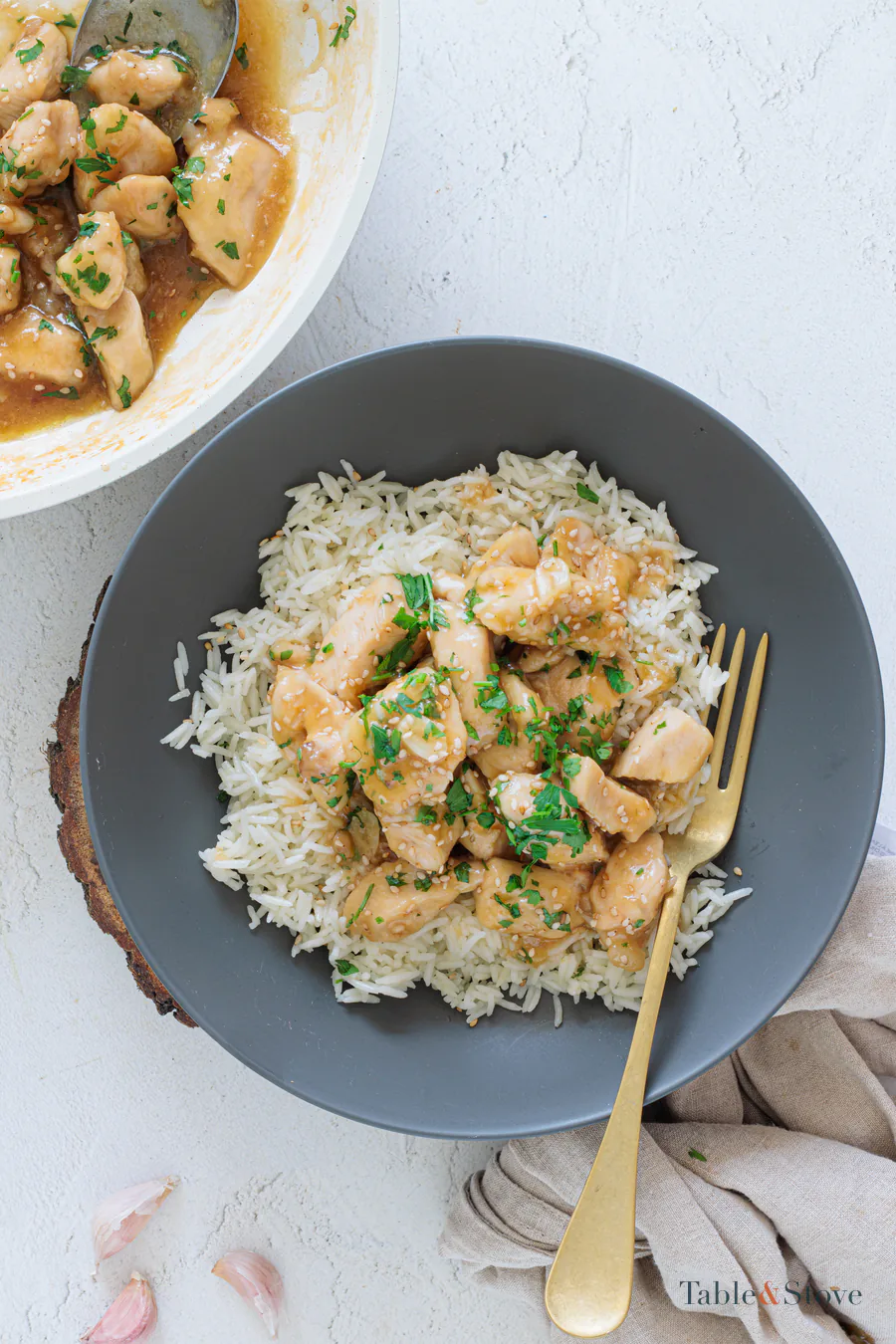 Honey garlic chicken served over rice with parsley