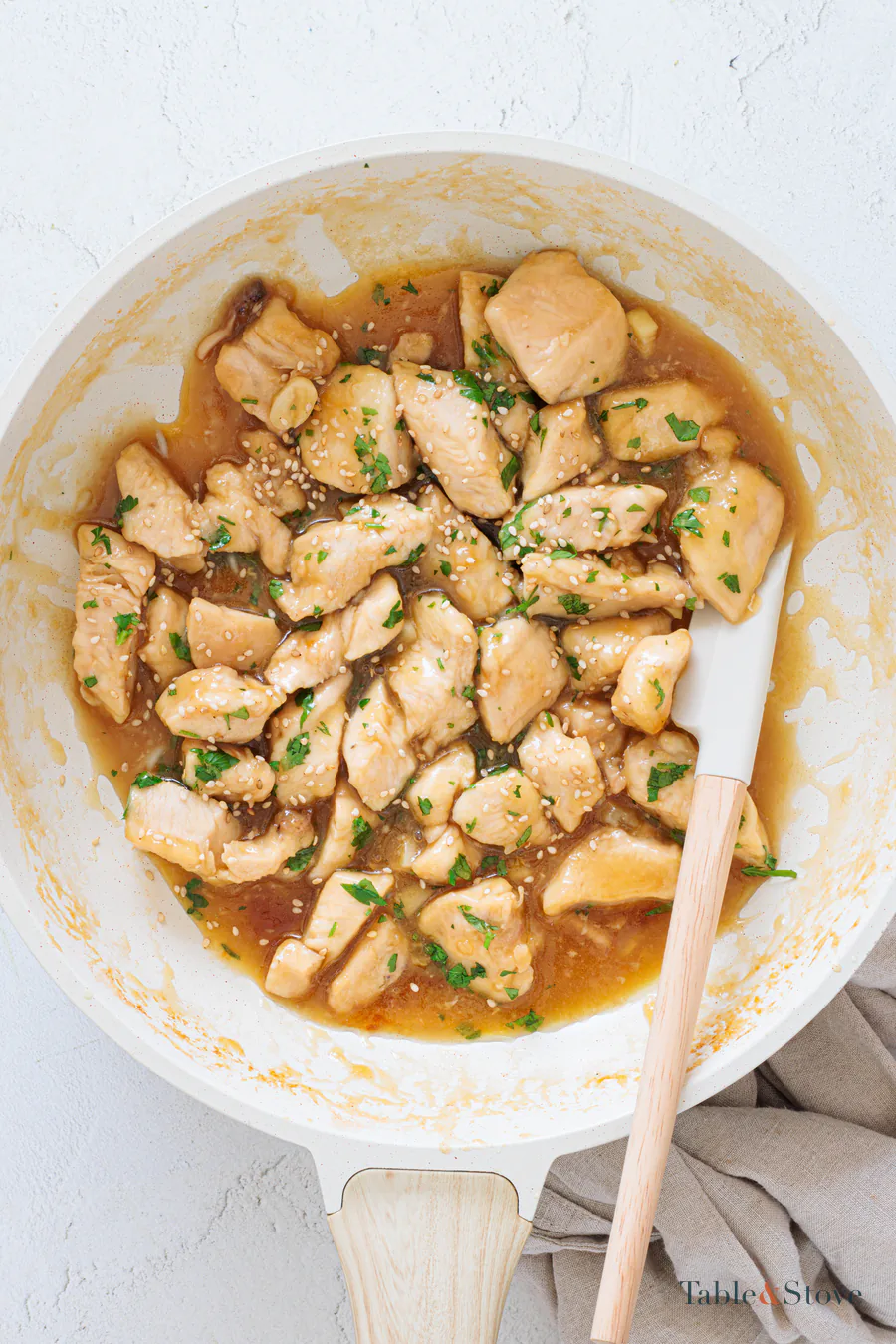 Chicken pieces coated in a thick glossy glaze in a skillet