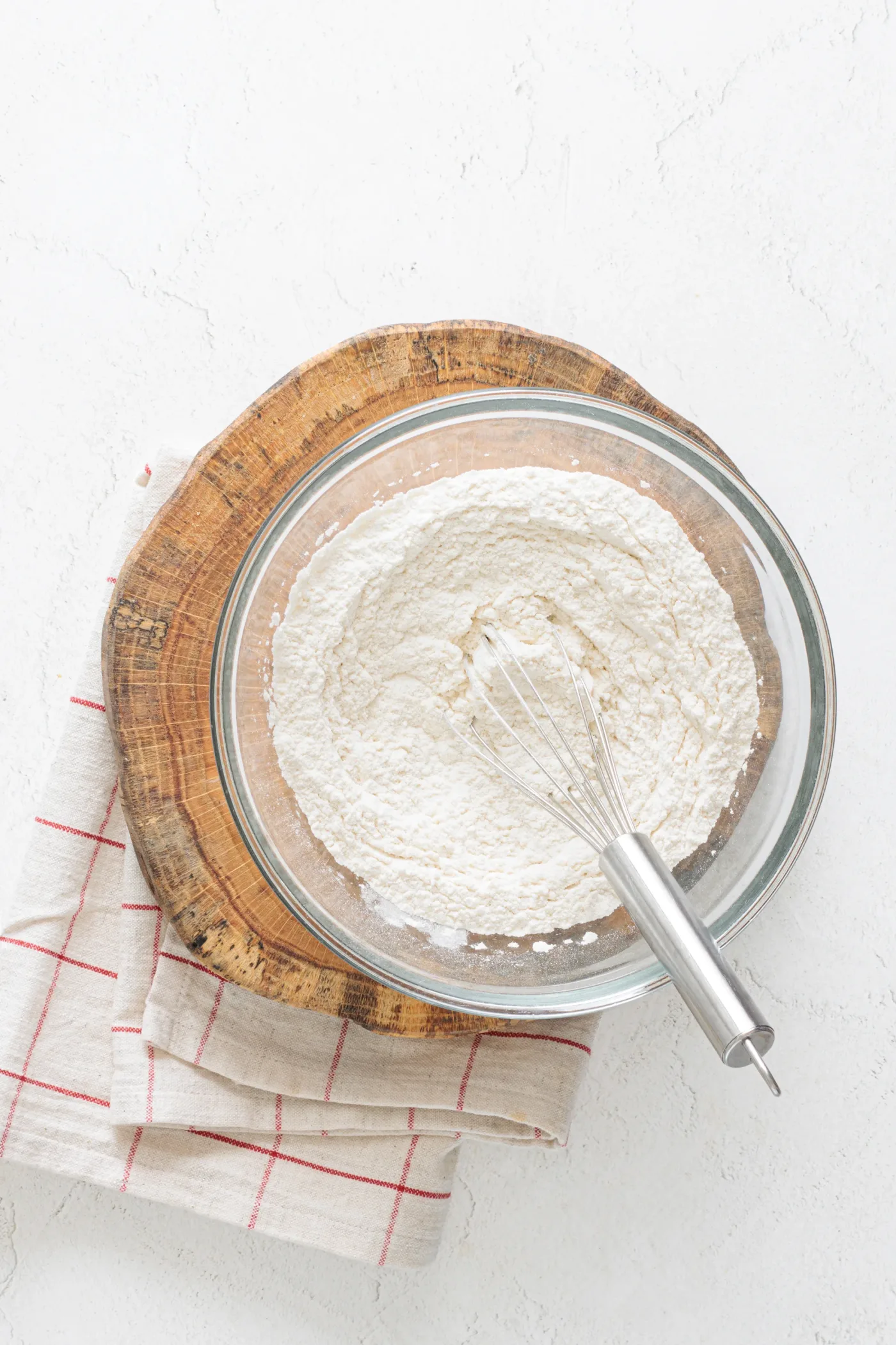Flour and baking powder whisked together in a glass bowl