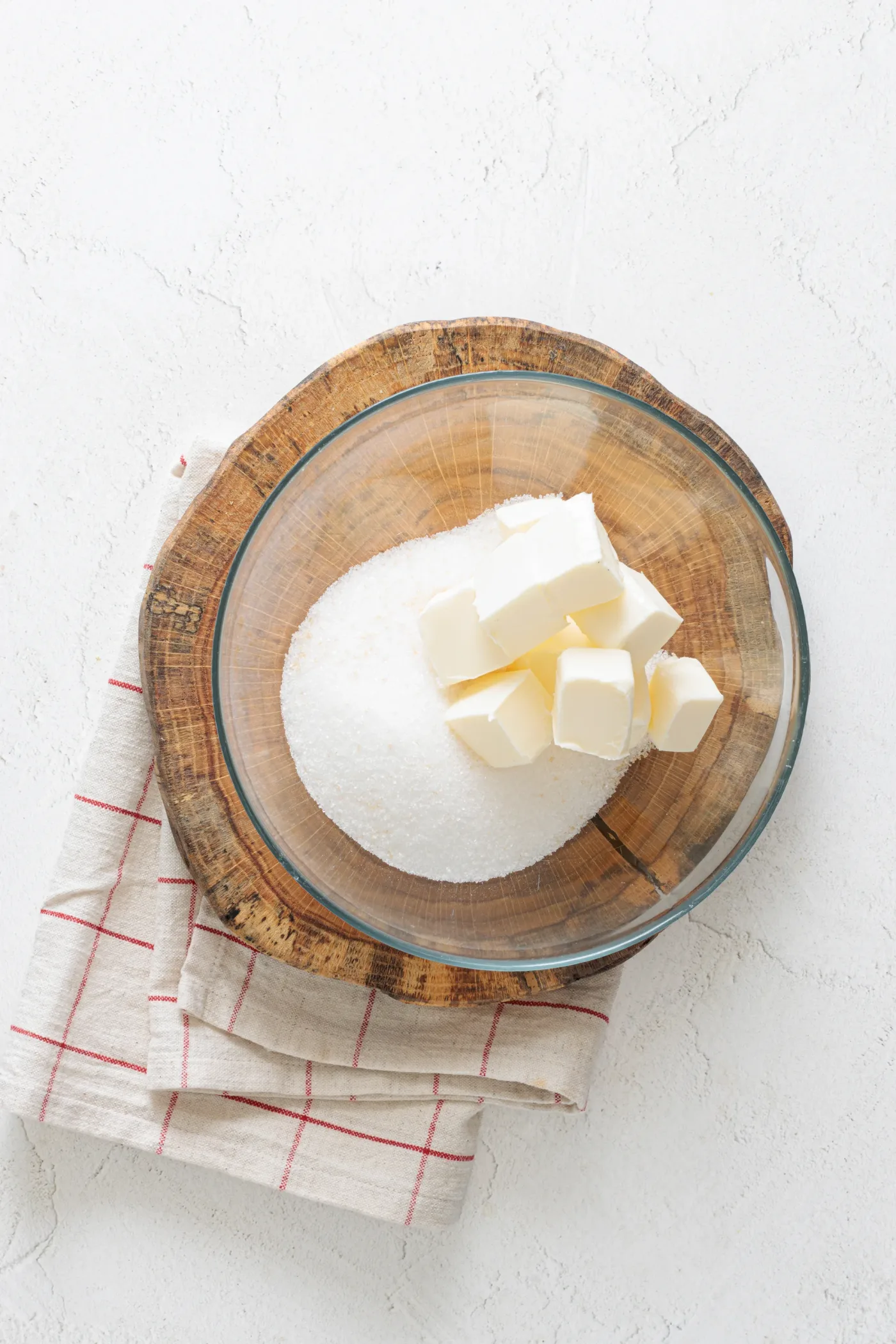 Softened butter and granulated sugar in a glass bowl