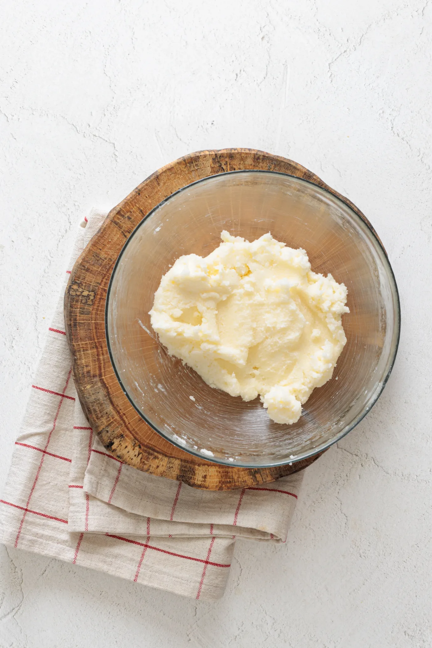 Pale creamed butter and sugar mixture in a glass bowl