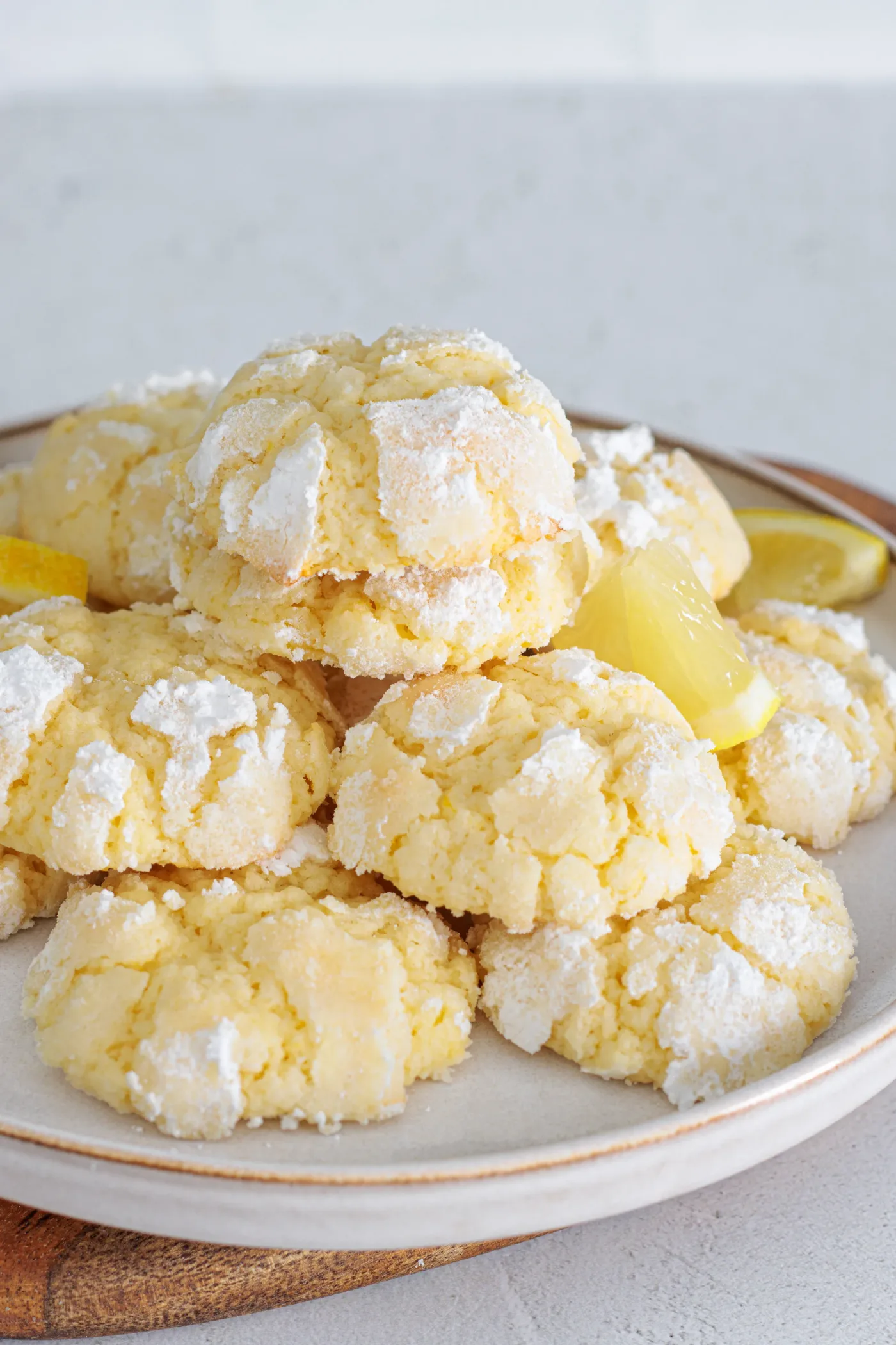 Baked lemon crinkle cookies with powdered sugar cracks on a baking sheet