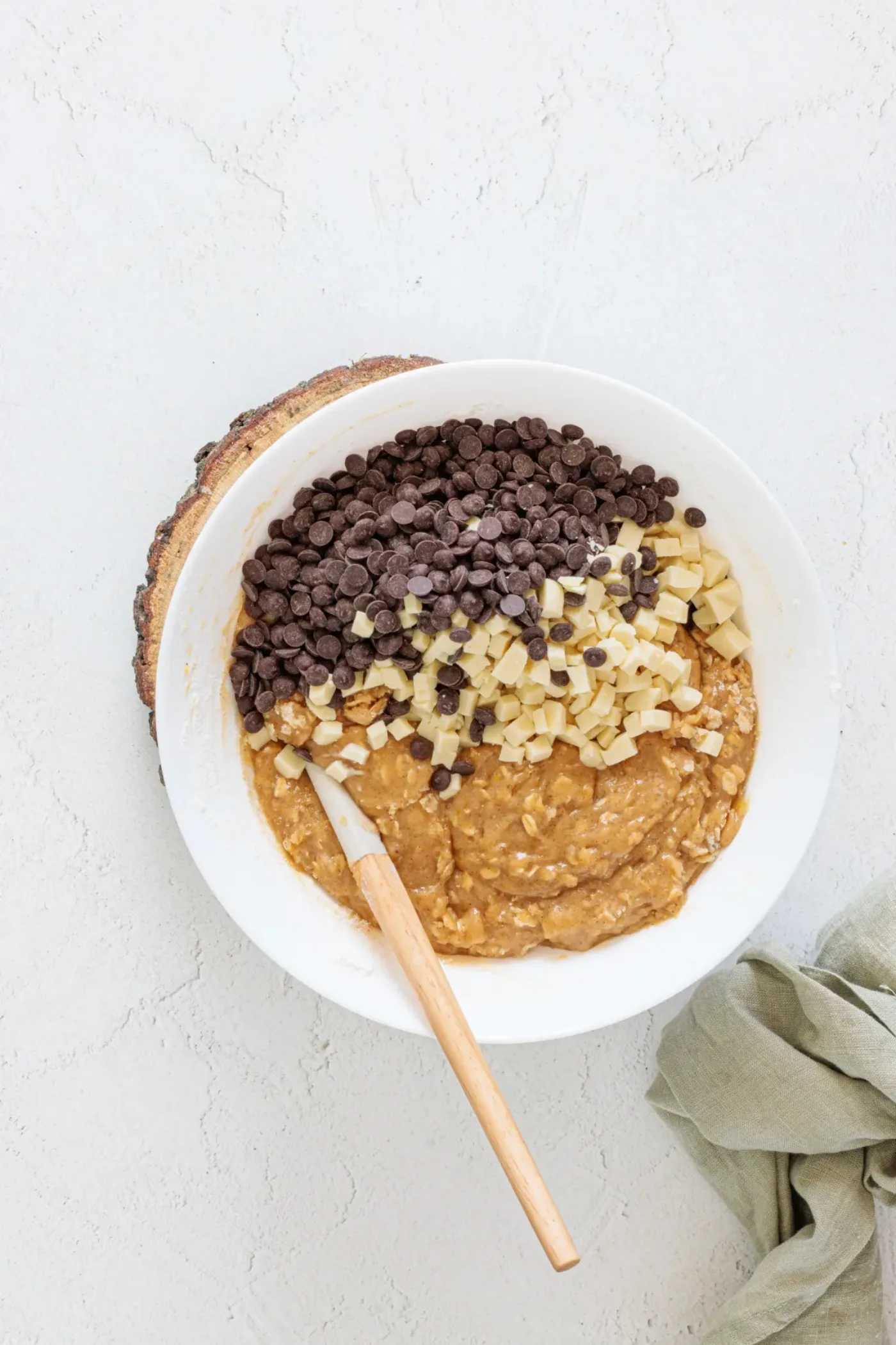 White and dark chocolate chips added to oat cookie dough