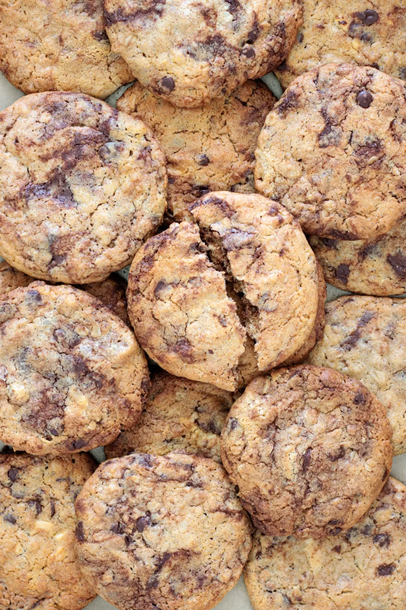 Close-up of golden brown butter cookies with oats and melted chocolate