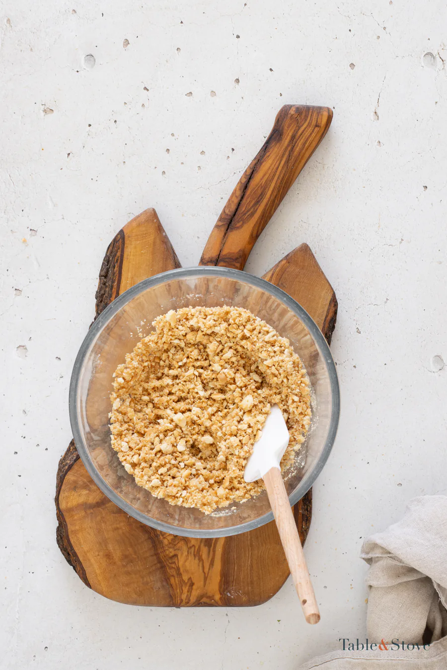 Fine cookie crumbs mixed with sunflower oil in a glass bowl