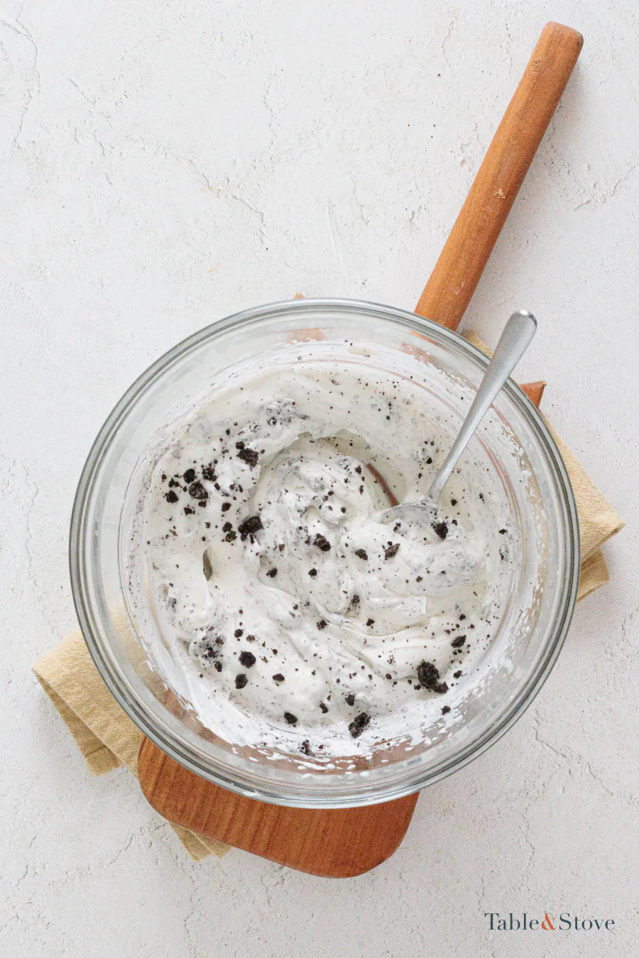 Crushed Oreo pieces folded into whipped cream cheese filling
