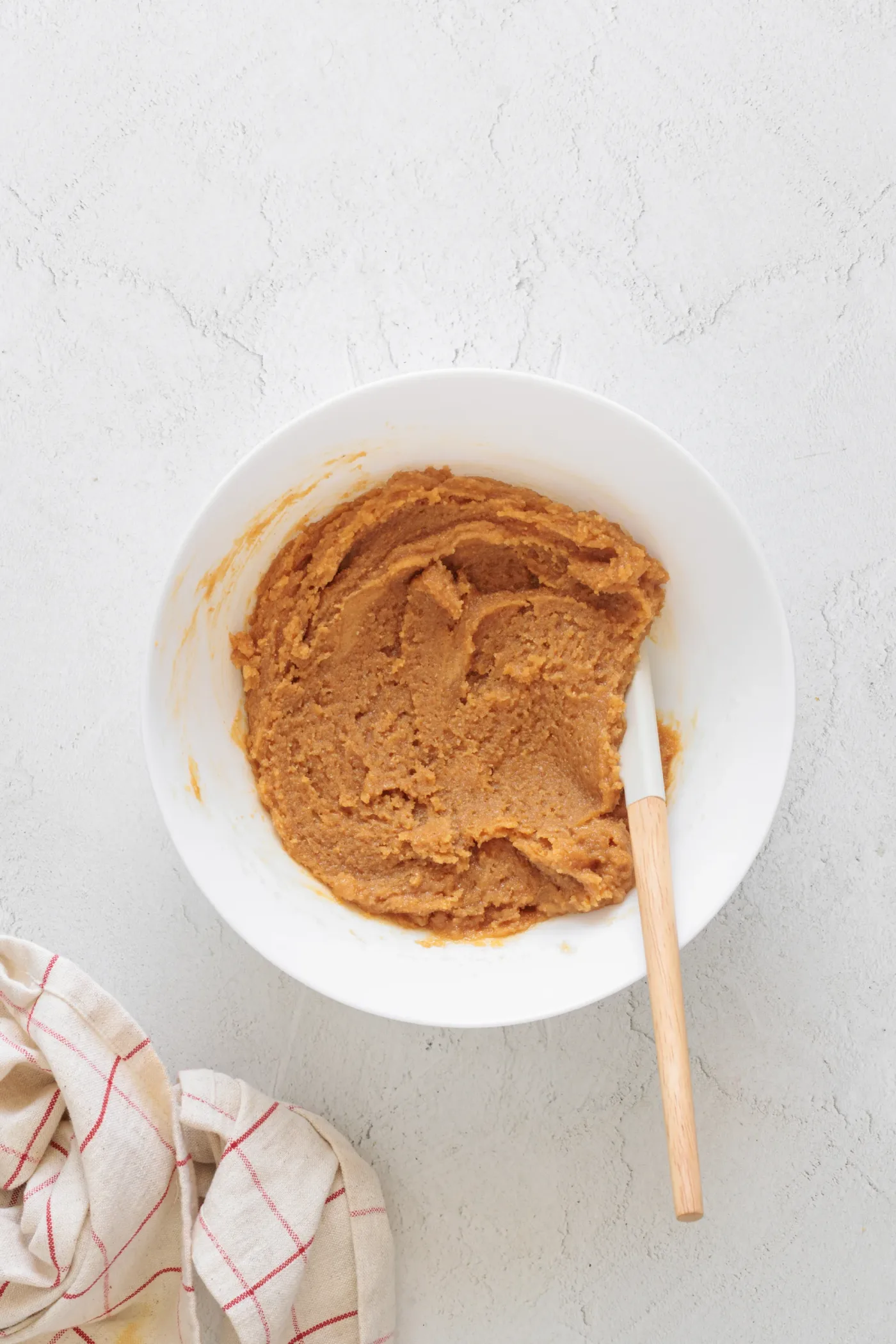 Smooth mixed peanut butter cookie dough in a bowl with a spatula