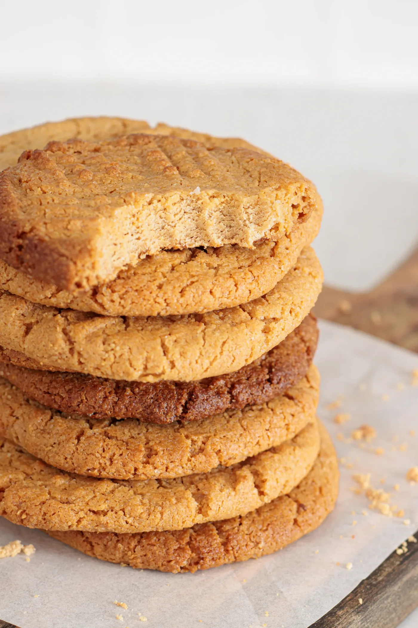 Stack of baked peanut butter cookies with one cookie broken open