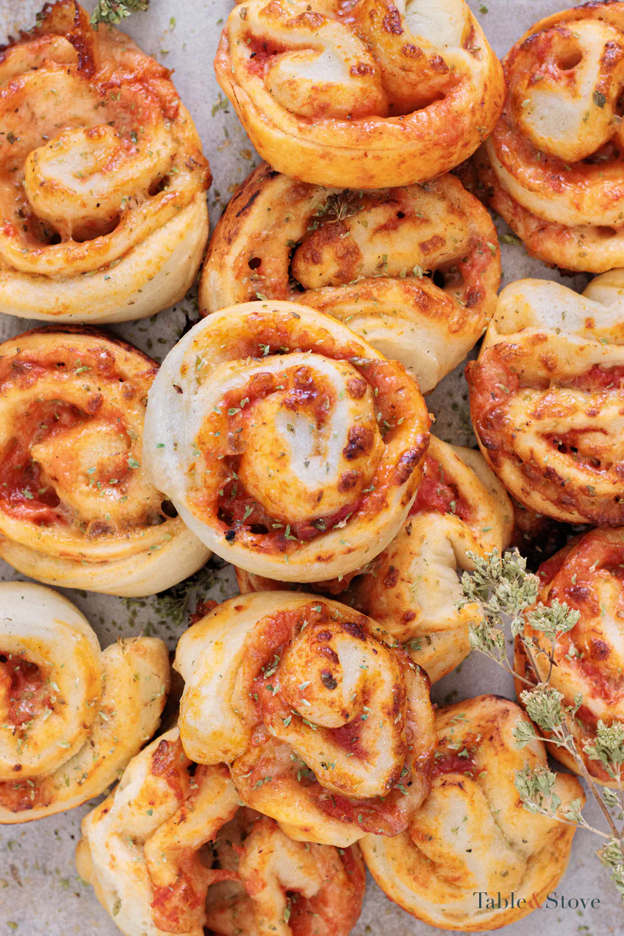Golden pizza pinwheels with tomato and melted mozzarella spirals