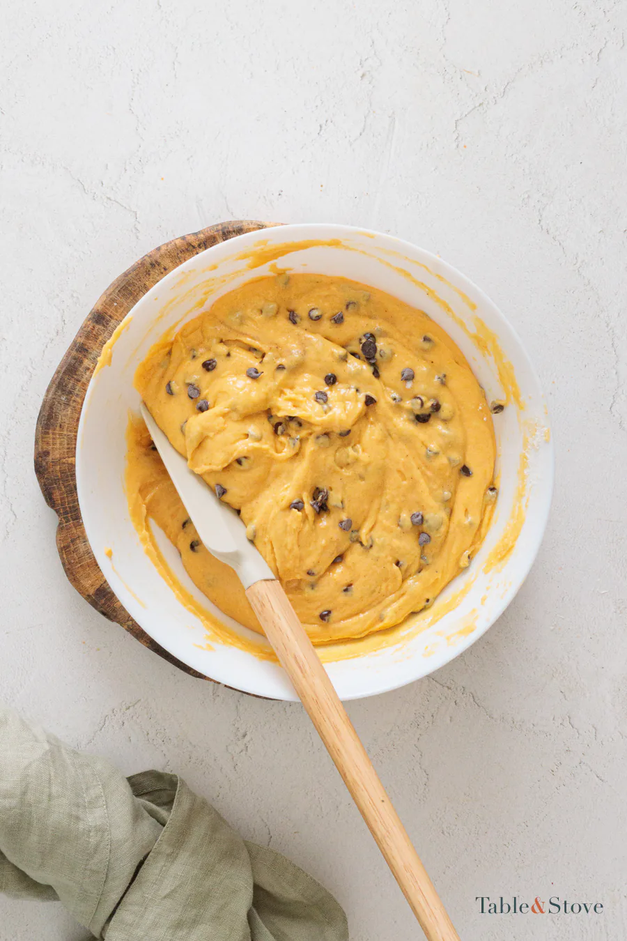 Chocolate chips dispersed in orange pumpkin bread batter
