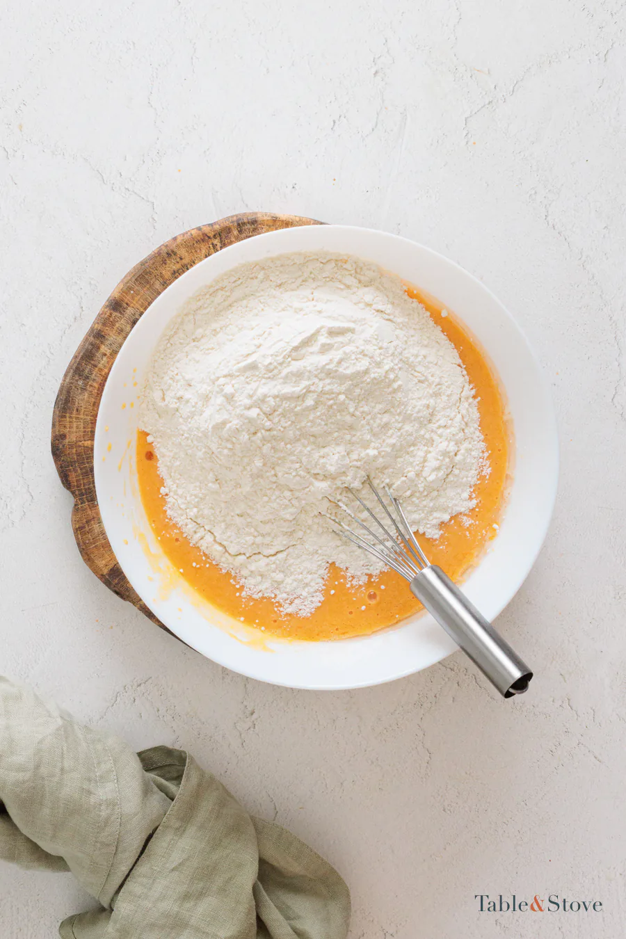 Flour added on top of the orange pumpkin mixture