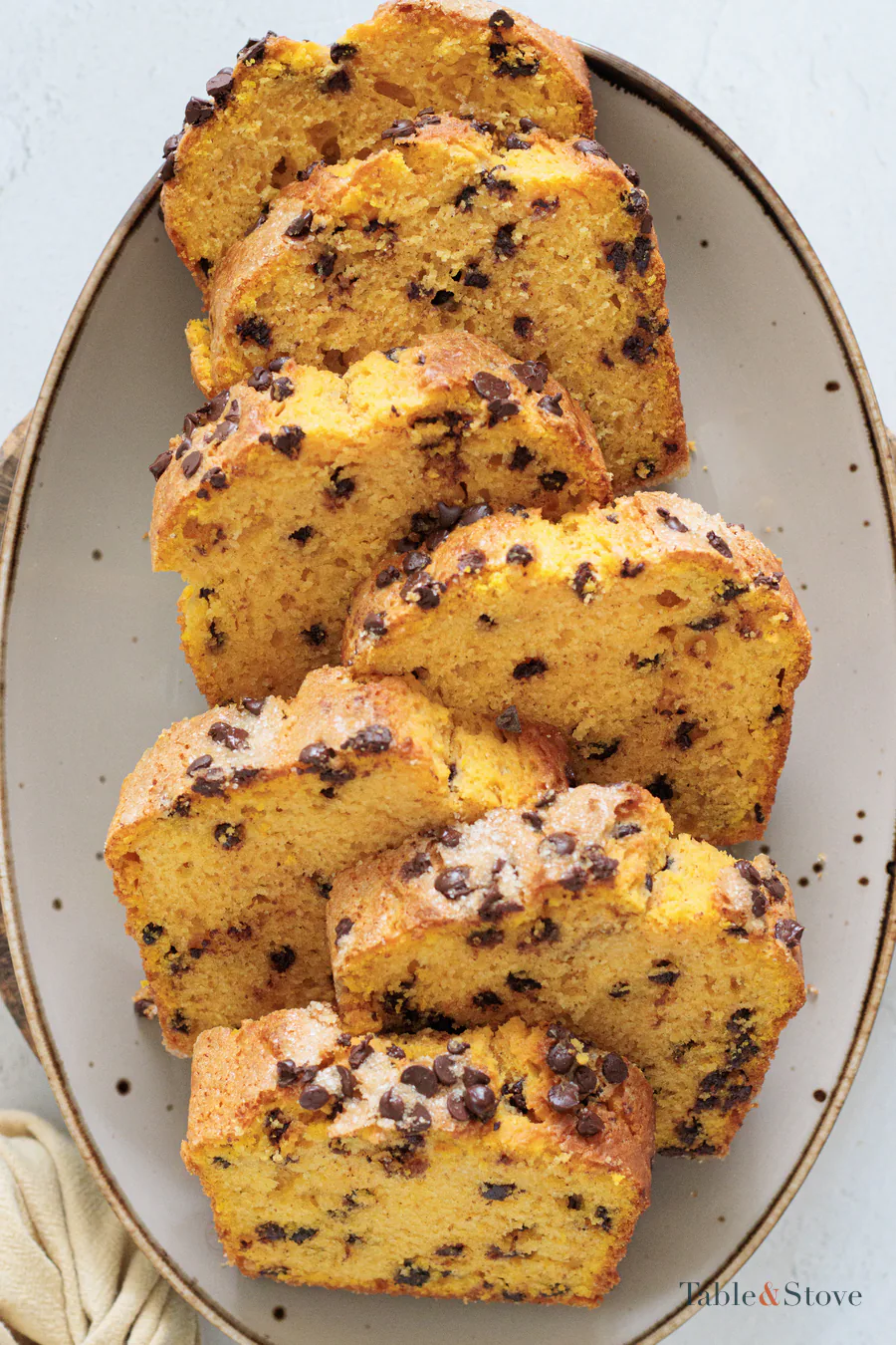 Several slices of pumpkin bread arranged on a plate