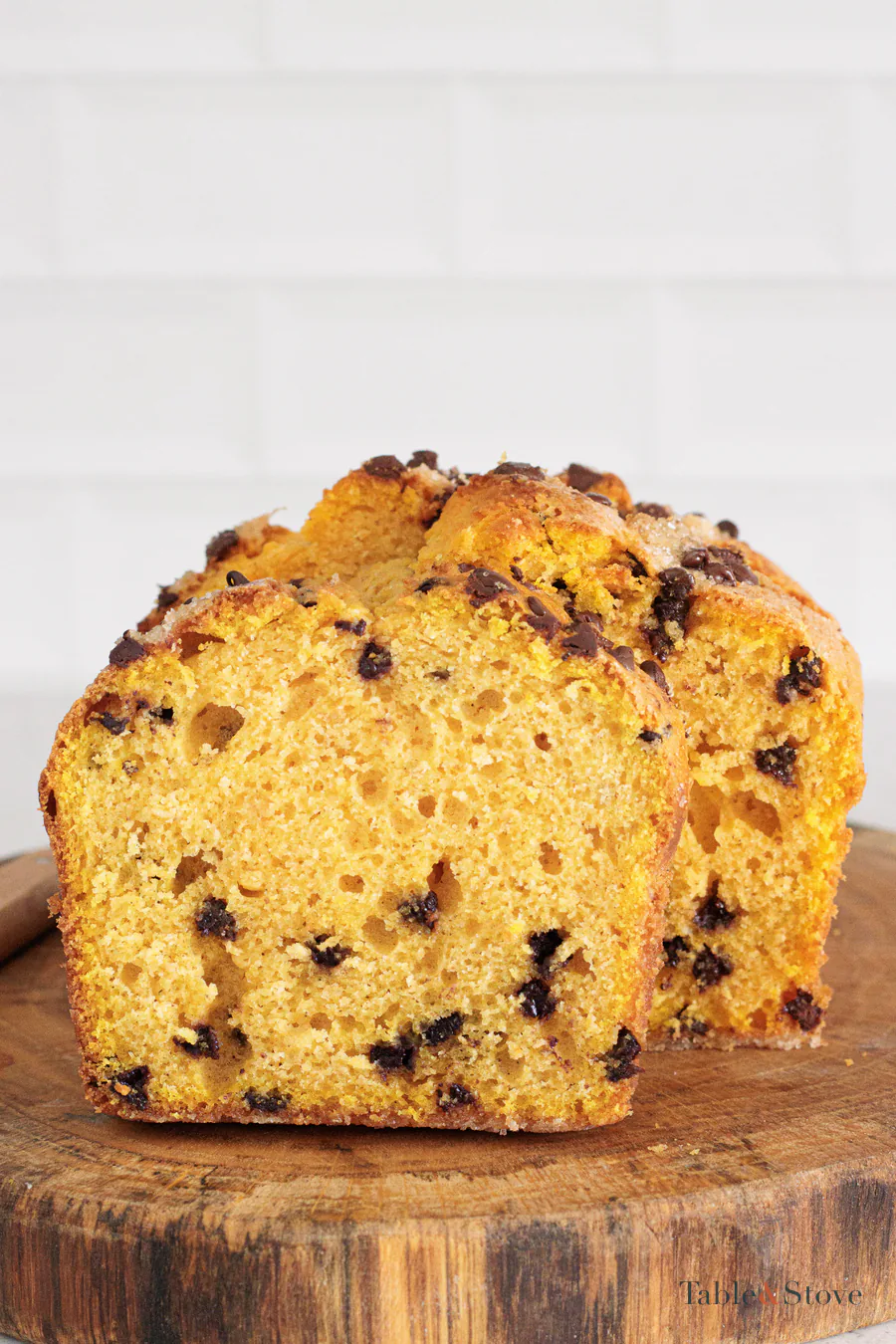 Close view of a pumpkin bread slice with chocolate chips in the orange crumb