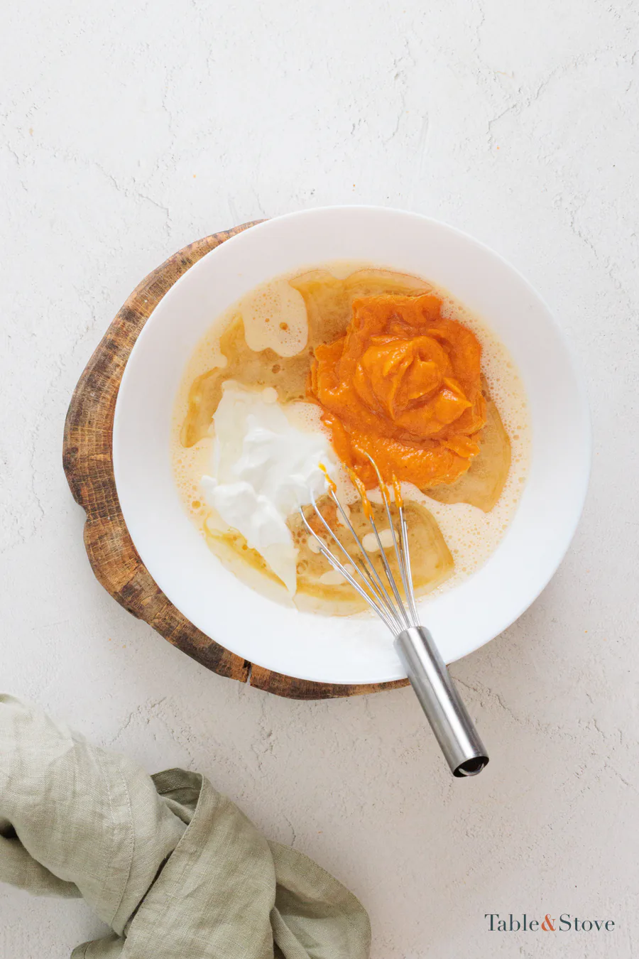 Pumpkin puree, oil, and soy yogurt in a bowl before they are mixed