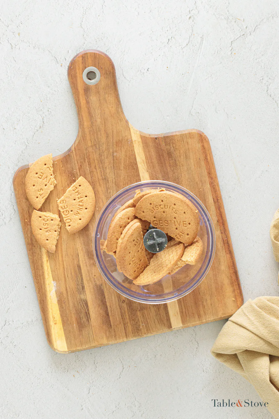 Digestive-style cookies in a food processor before crushing