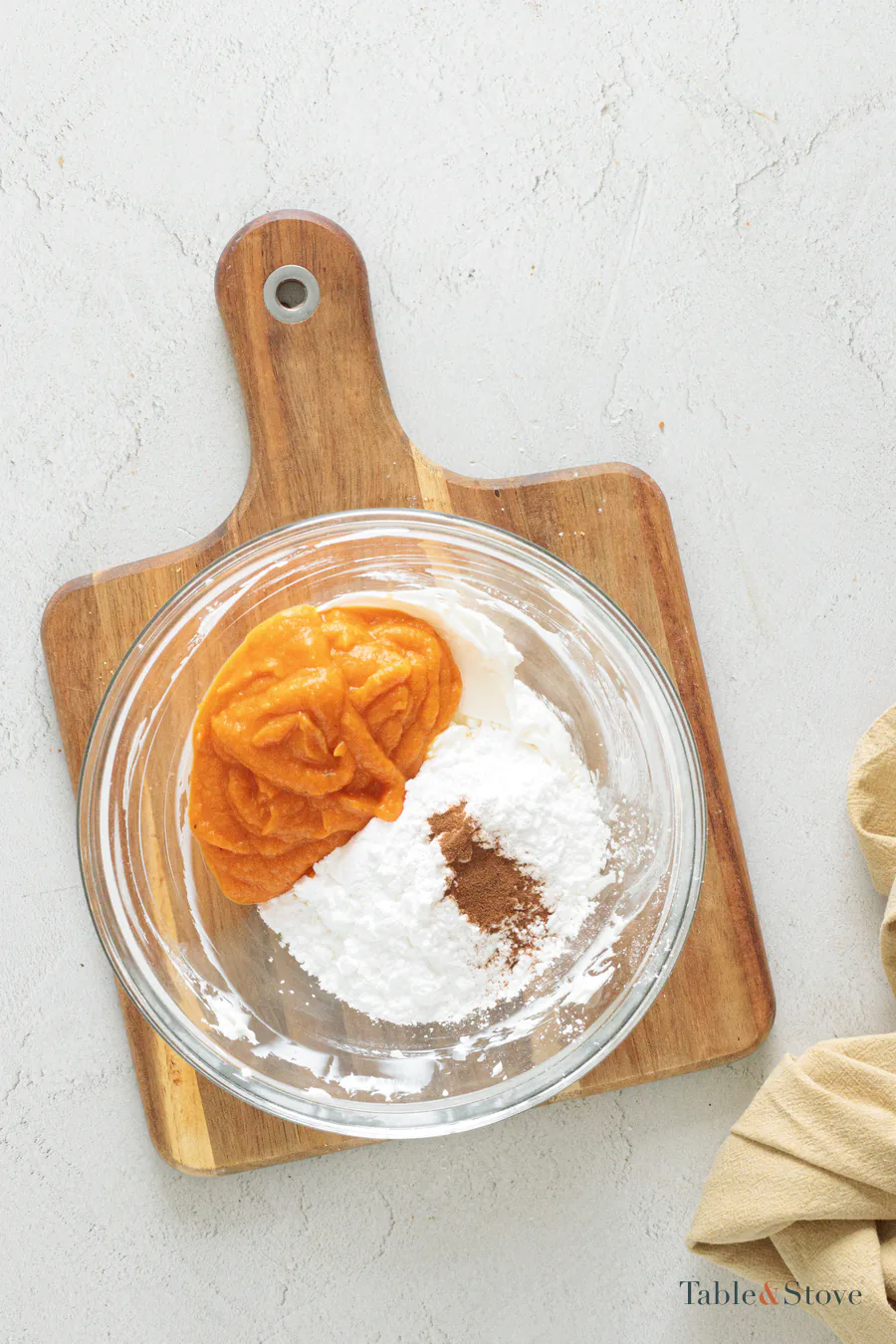 Pumpkin puree, cream cheese, powdered sugar, and cinnamon together in a mixing bowl