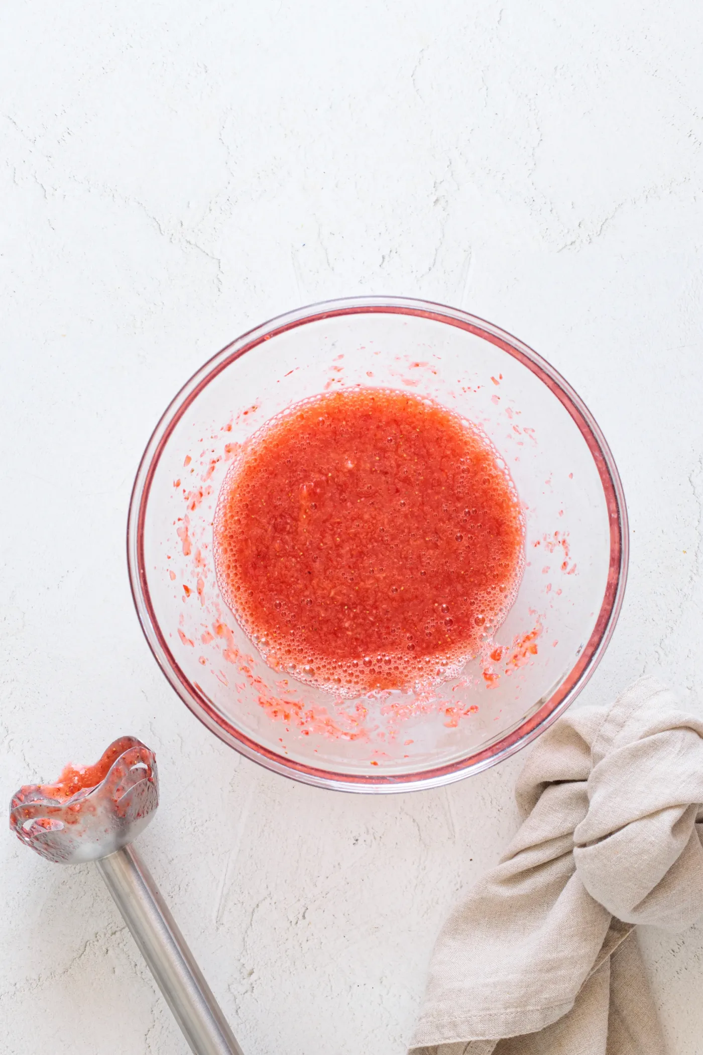 Smooth blended strawberry purée in a glass bowl