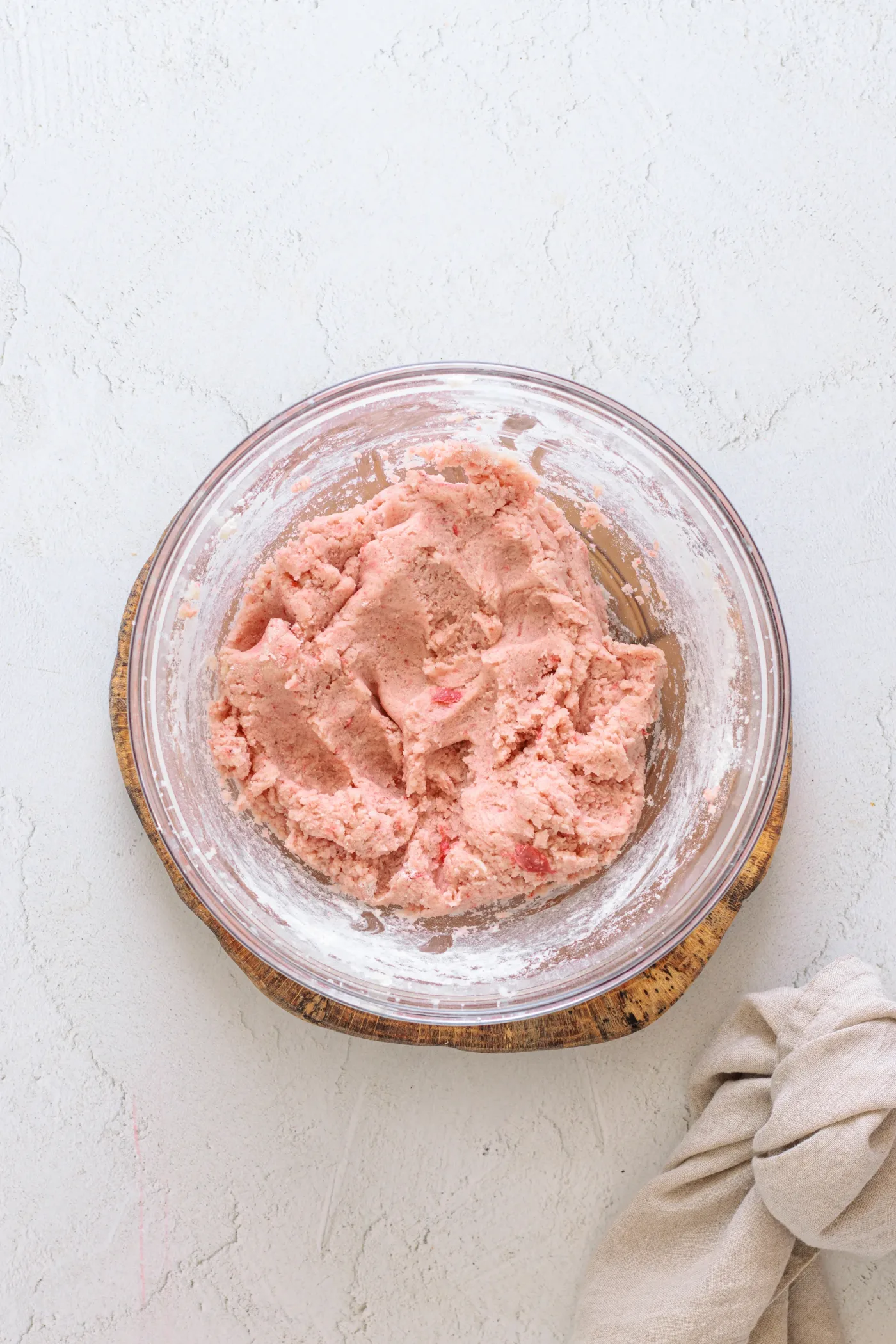 Finished soft pink strawberry cookie dough in a glass bowl