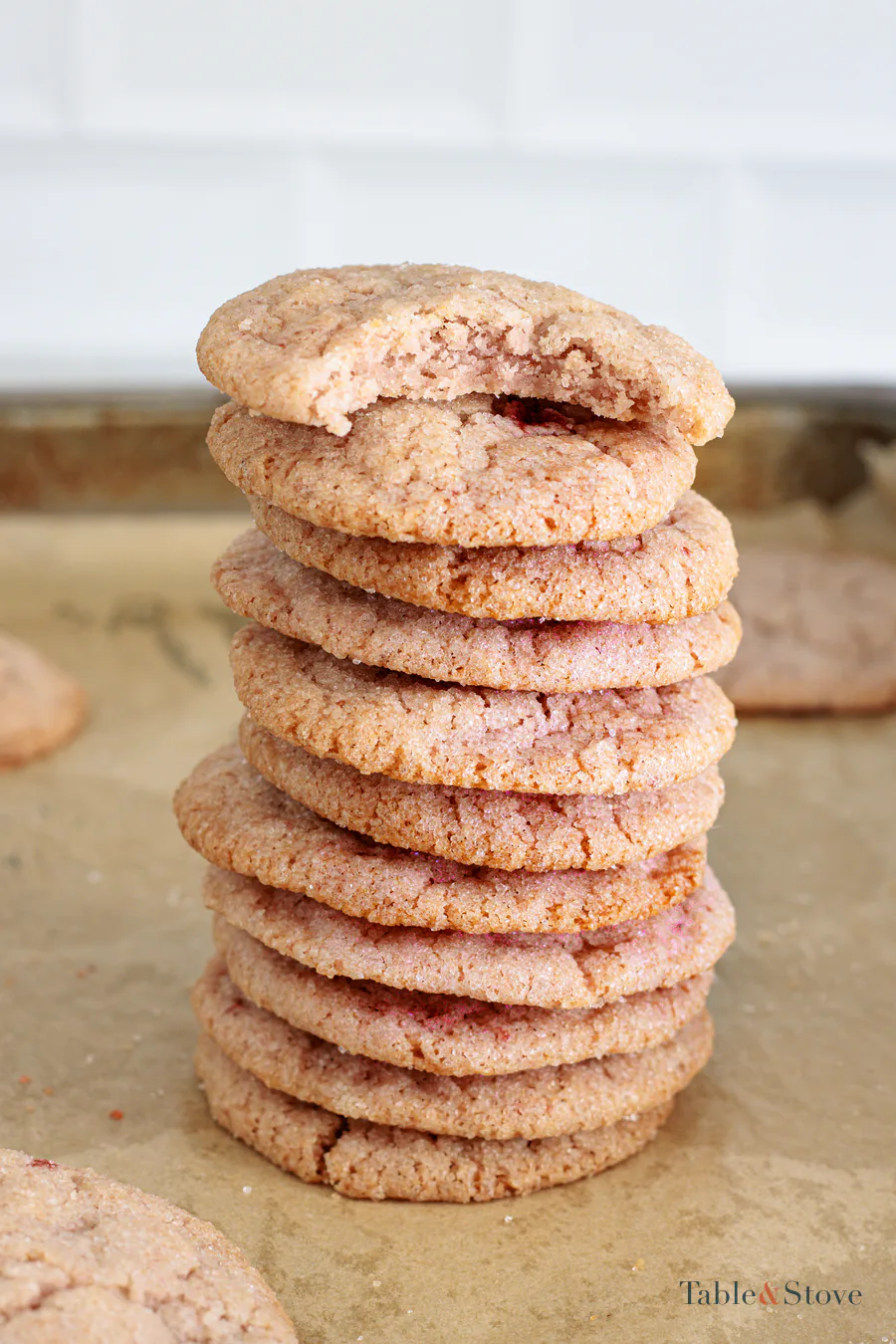 Stack of strawberry sugar cookies with one broken open